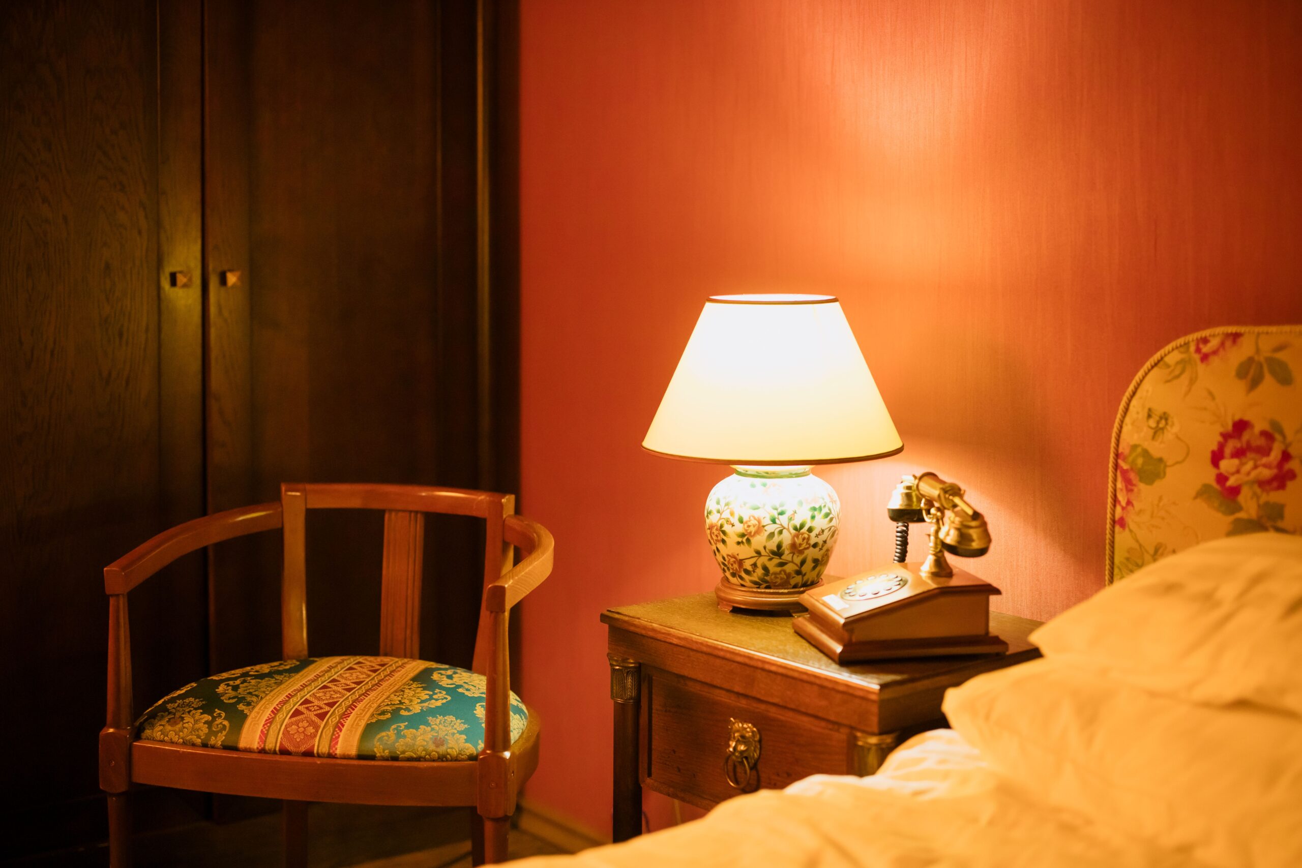 Warm bedside lamp creating soft ambient lighting in a cozy bedroom at night.