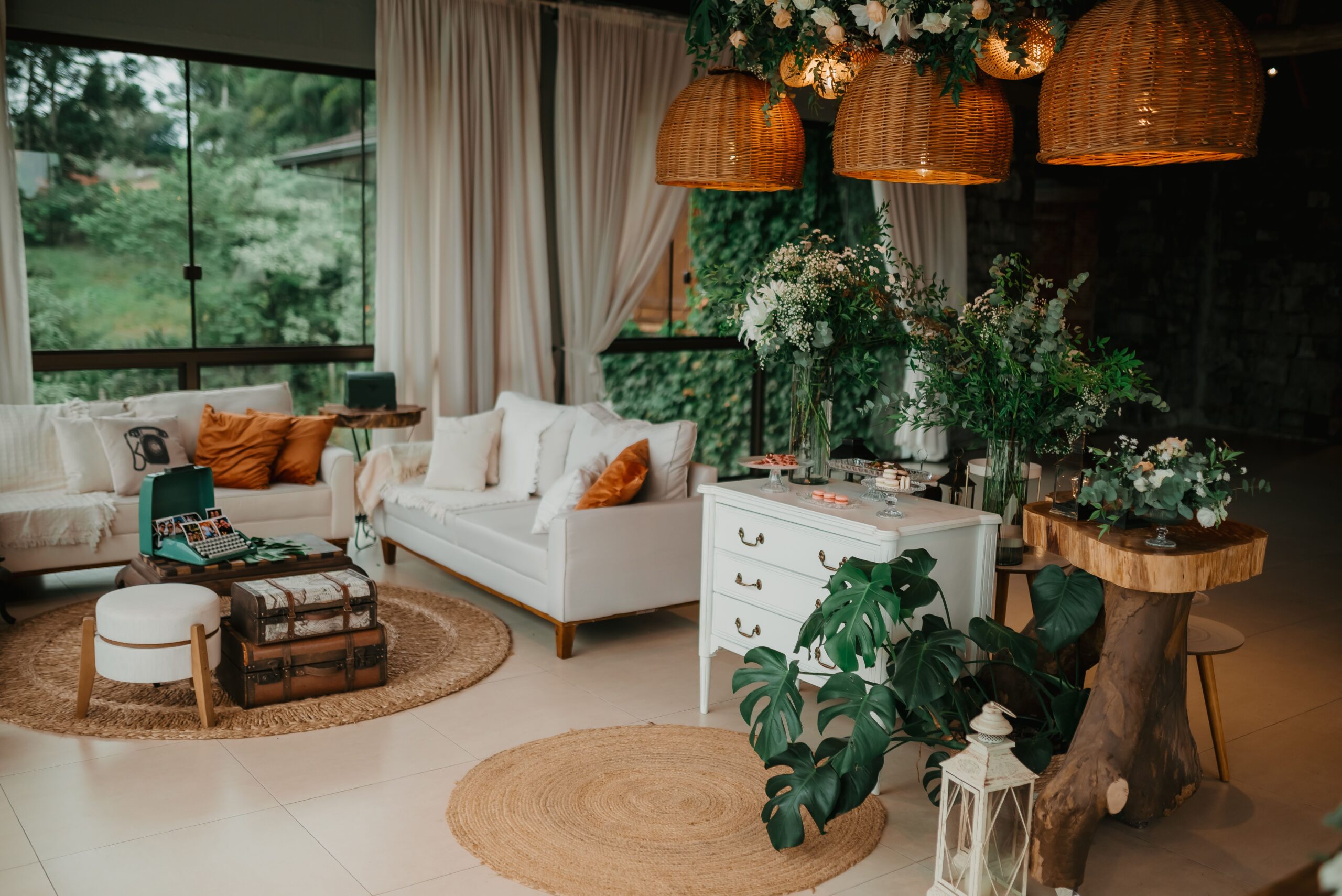 Bright boho living room with rattan pendant lights, jute rugs, and neutral decor