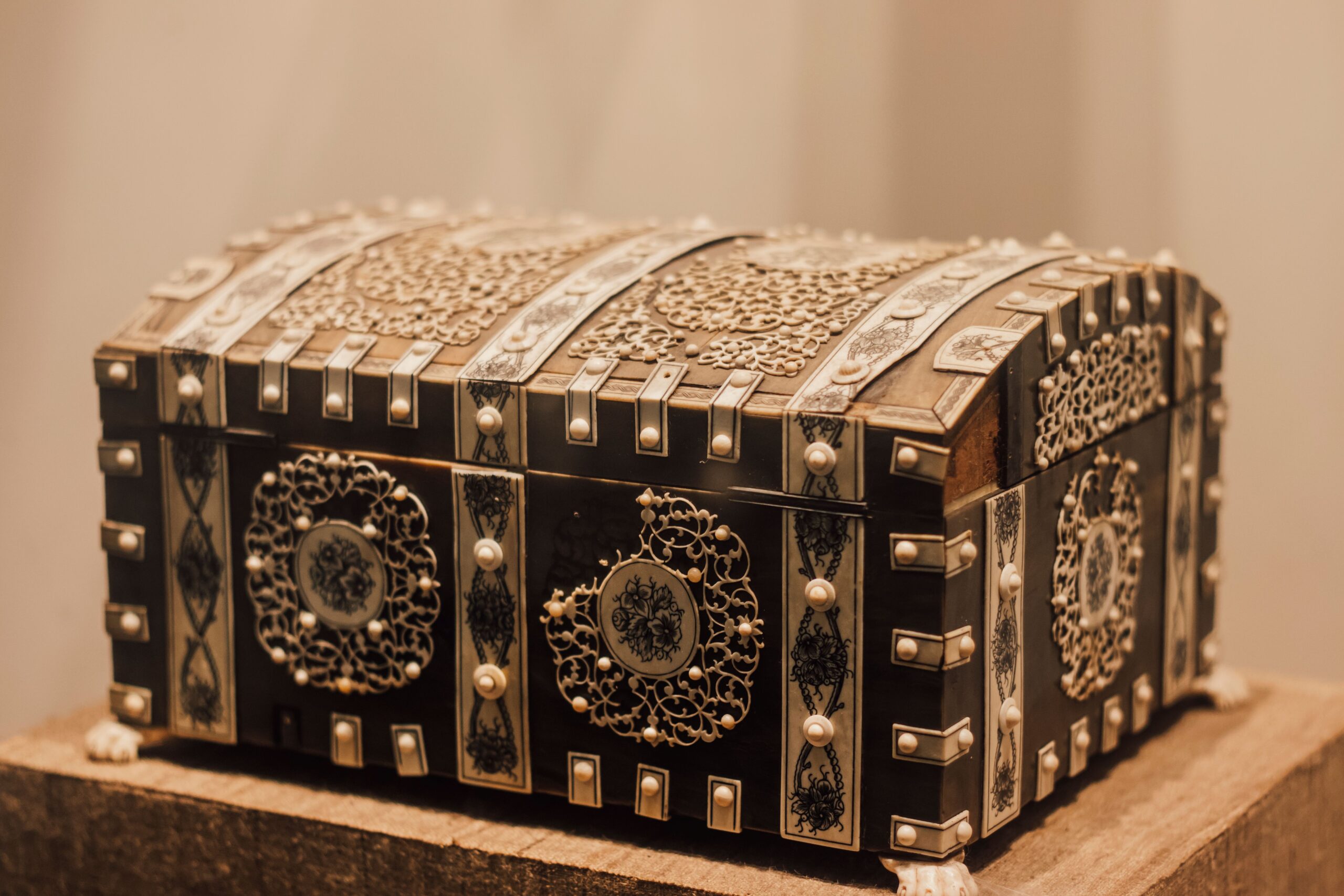 Decorative storage box for organizing small everyday items on a bedroom dresser.